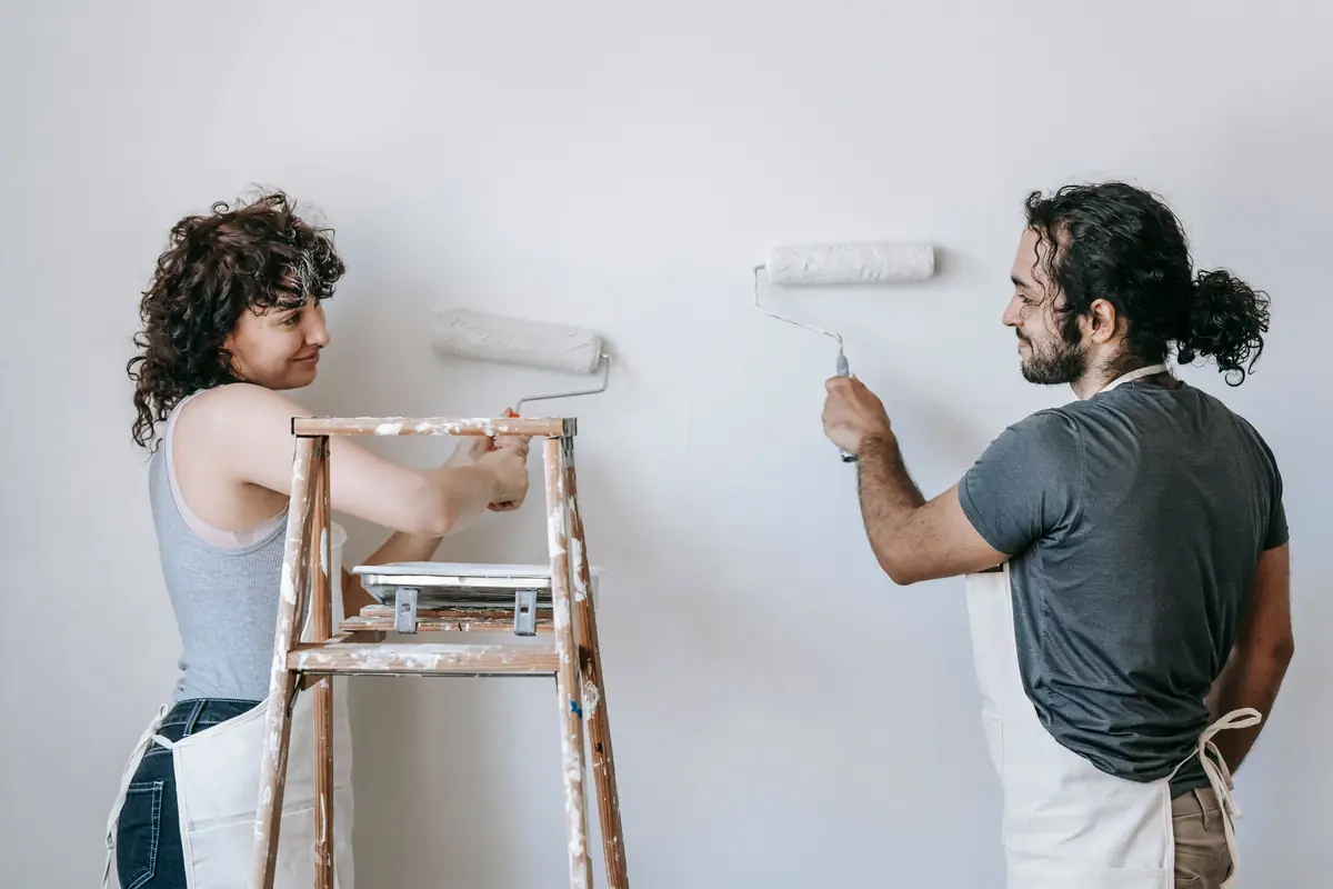 People painting a wall together — painting help in Savannah