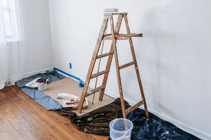 Rental turnover painting in Savannah: empty unit with fresh white walls and a stepladder